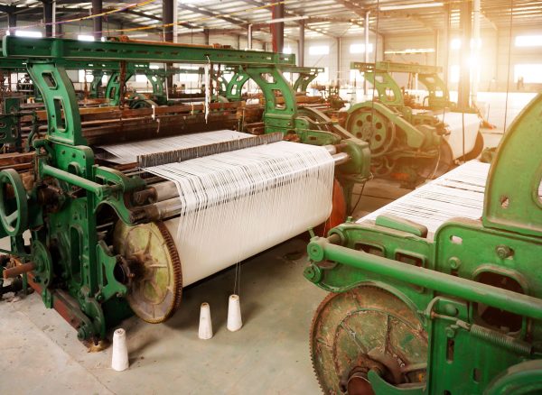 Old-fashioned loom, arranged in the factory workshop.